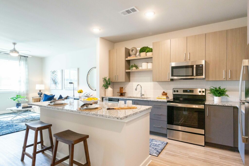 Here to Redefine Luxury Living - luxury apartment interior with granite countertops and stainless steel appliances